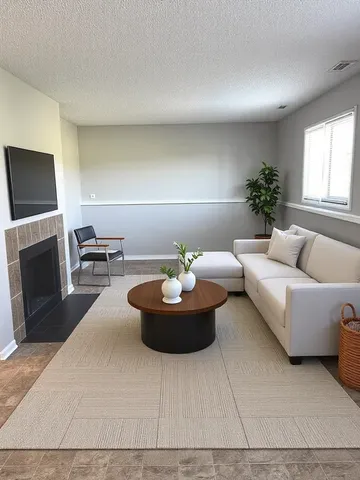 a living room with furniture a window and a fireplace