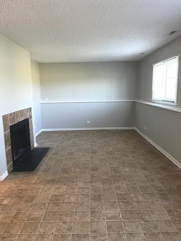 wooden floor in an empty room with a fireplace
