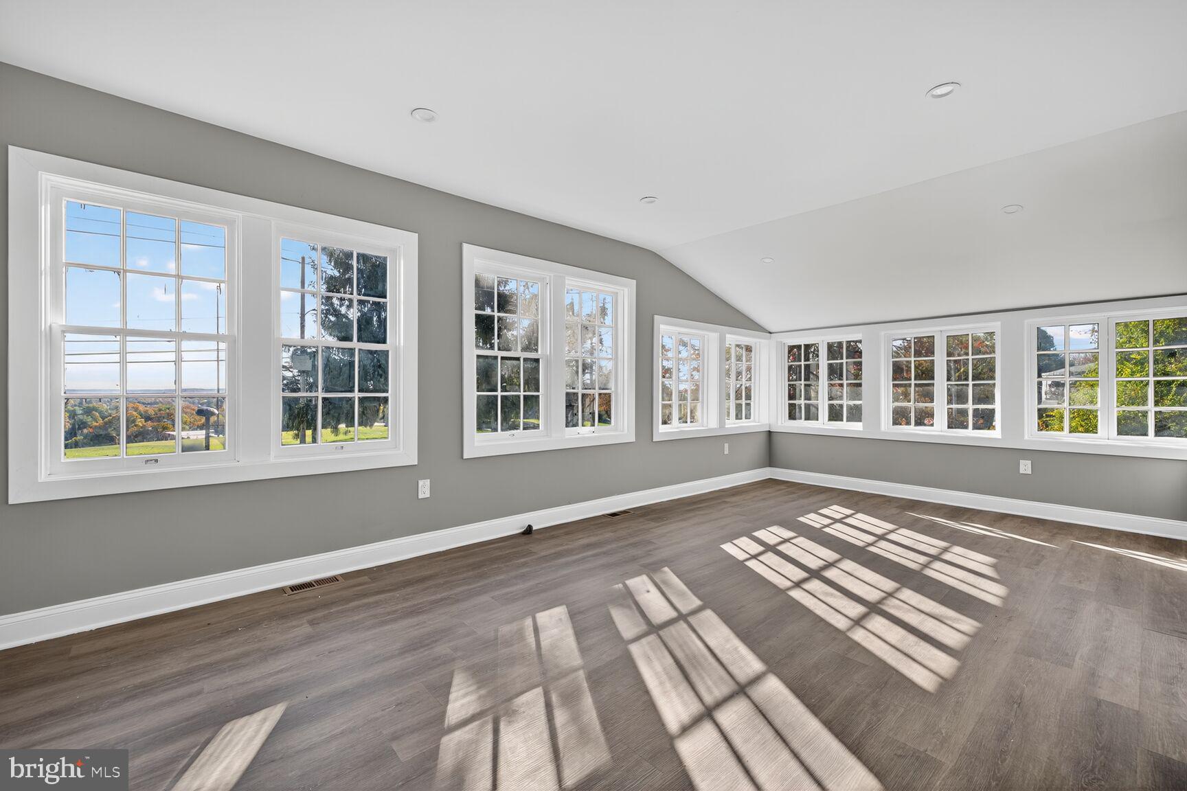 401 Linden Avenue Frederick, MD 21703 - Photo 11 of 29 a view of an empty room with a window and wooden floor