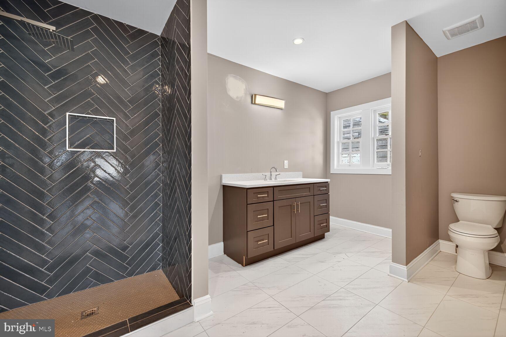 401 Linden Avenue Frederick, MD 21703 - Photo 15 of 29 a spacious bathroom with a vanity toilet a sink and mirror