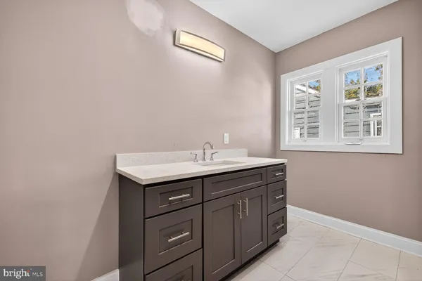 a bathroom with a sink a vanity and a window