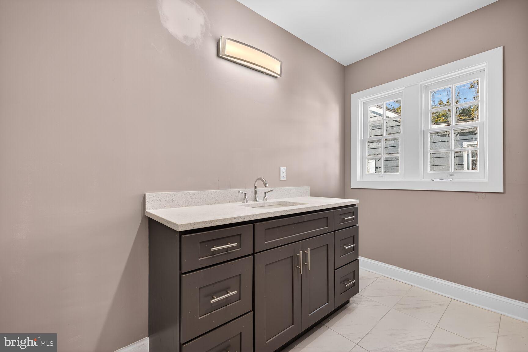401 Linden Avenue Frederick, MD 21703 - Photo 16 of 29 a bathroom with a sink a vanity and a window