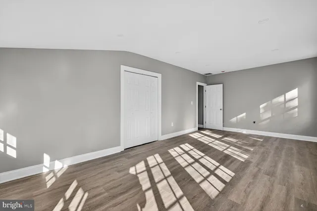 a view of a room with wooden floor and bedroom