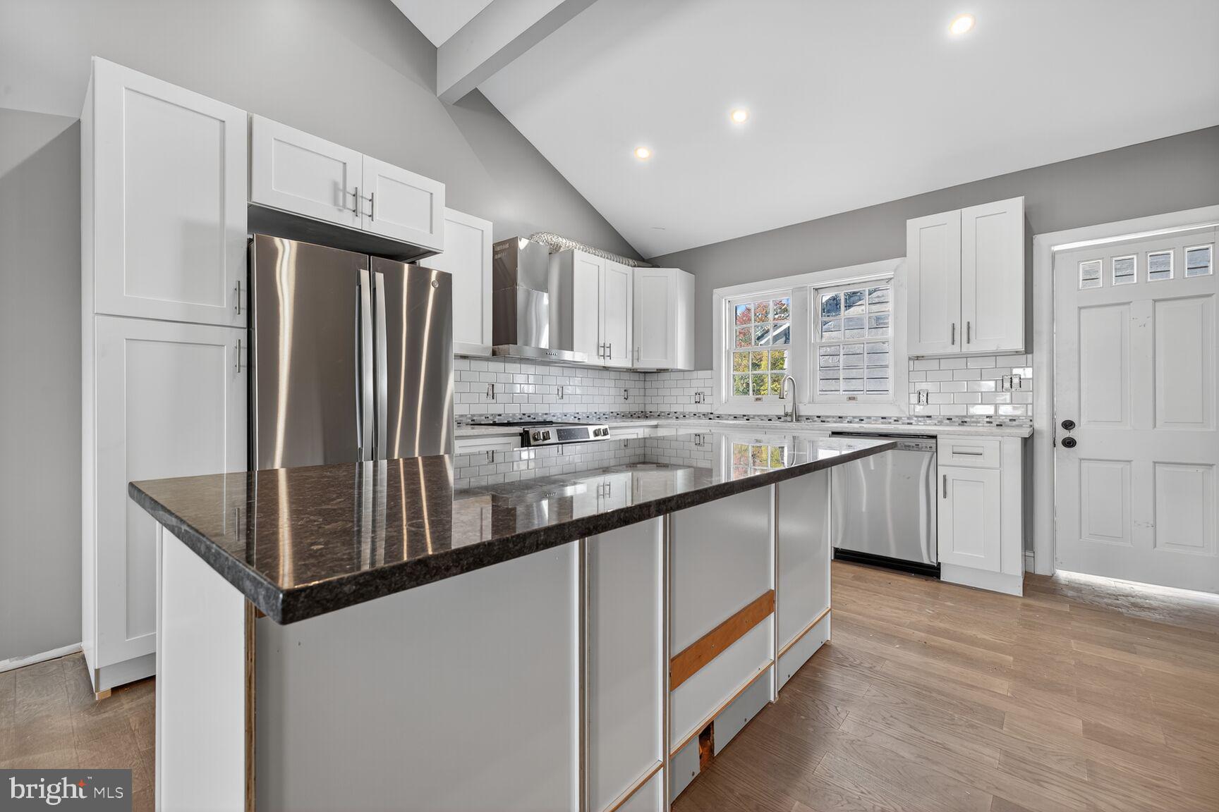 401 Linden Avenue Frederick, MD 21703 - Photo 2 of 29 a kitchen with stainless steel appliances granite countertop a refrigerator a sink dishwasher a stove and white countertops with wooden floor