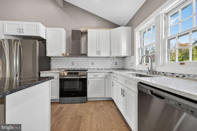 a kitchen with stainless steel appliances granite countertop a stove a sink dishwasher and a refrigerator