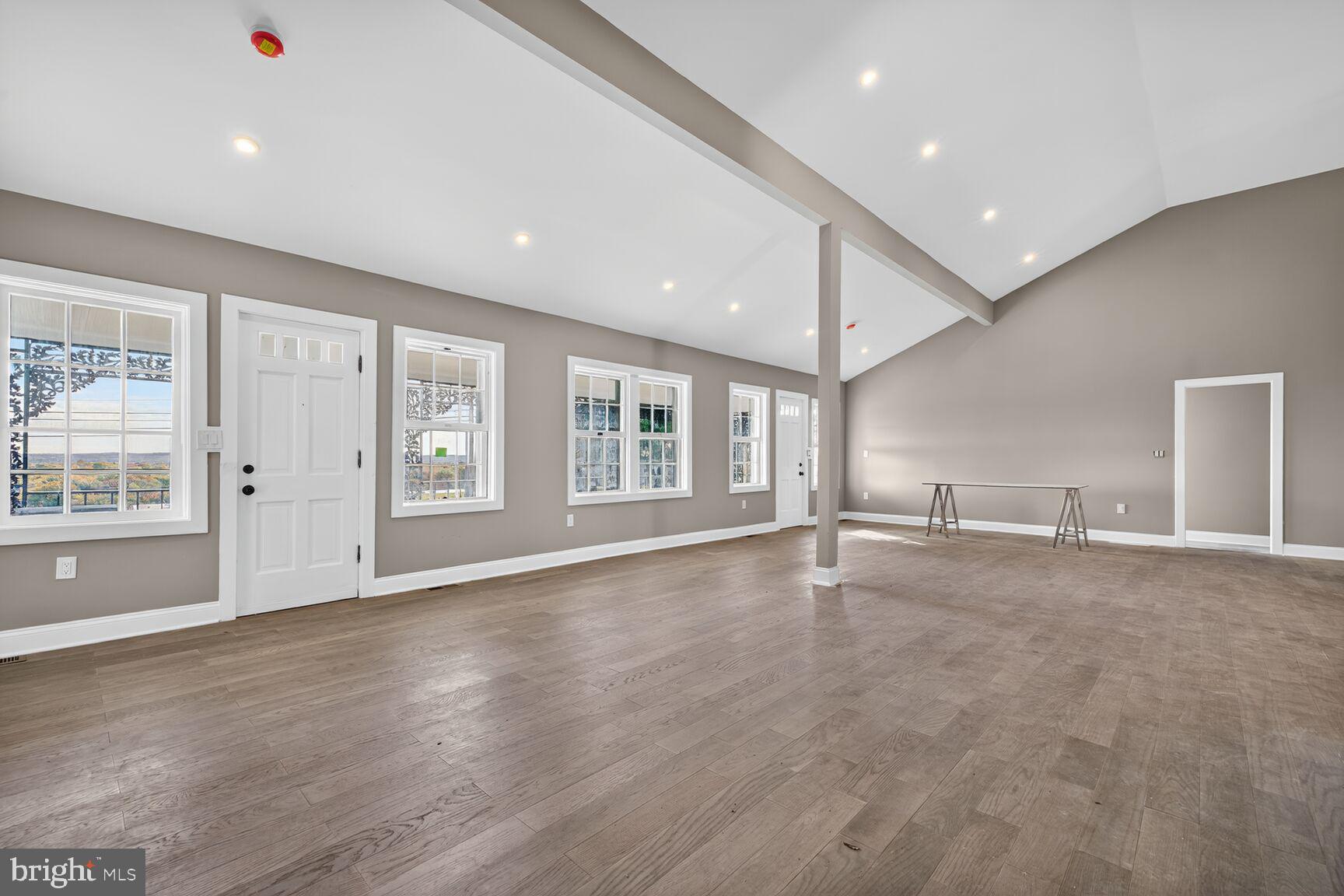 401 Linden Avenue Frederick, MD 21703 - Photo 4 of 29 an empty room with wooden floor and windows