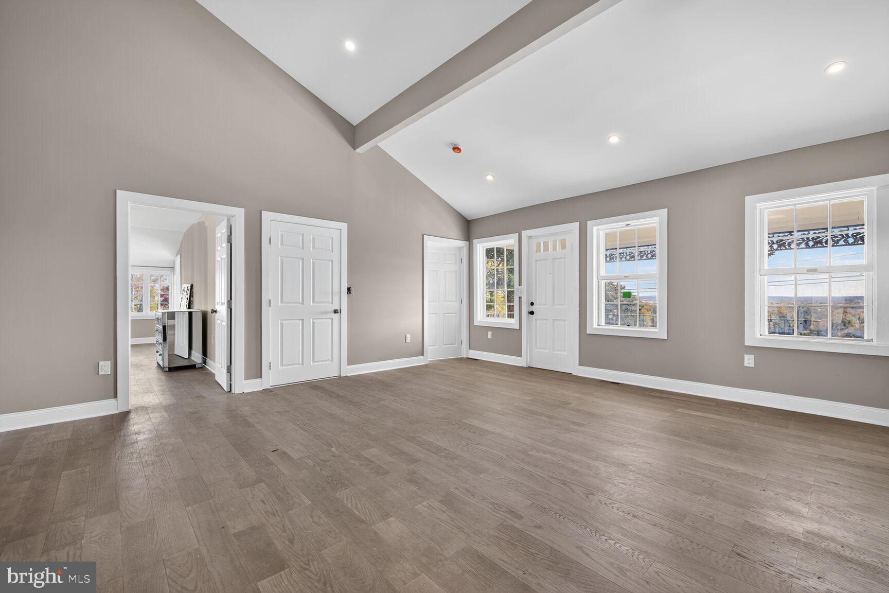 401 Linden Avenue Frederick, MD 21703 - Photo 5 of 29 an empty room with wooden floor and windows