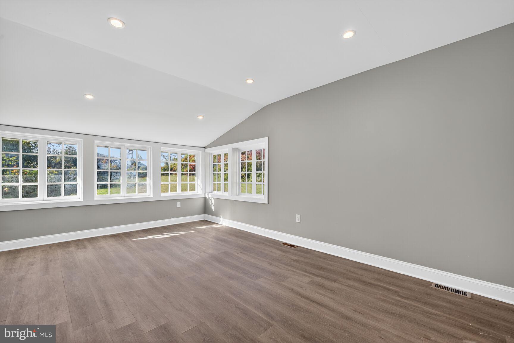 401 Linden Avenue Frederick, MD 21703 - Photo 10 of 29 an empty room with wooden floor and windows