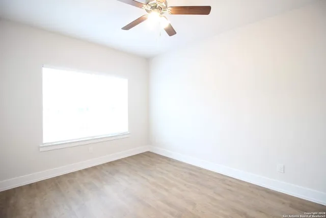 a view of a big room with closet and fan