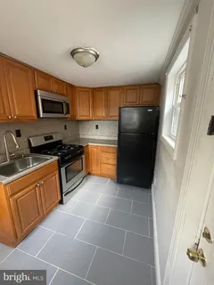 a kitchen with a refrigerator a stove top oven a sink and dishwasher