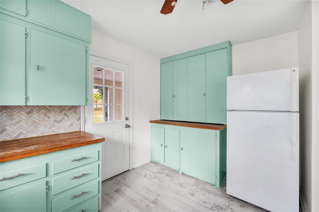 531 Coe Road Denison, TX 75021 - Photo 15 of 22 a kitchen with a refrigerator and a stove