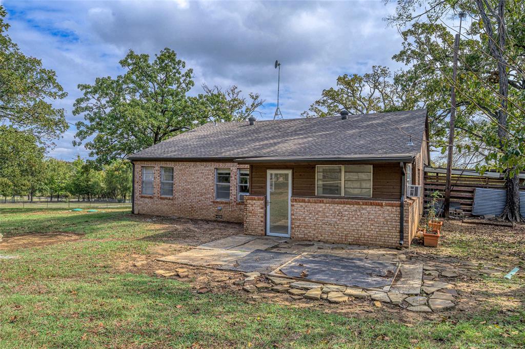 531 Coe Road Denison, TX 75021 - Photo 18 of 22 a view of a house with a yard and large tree