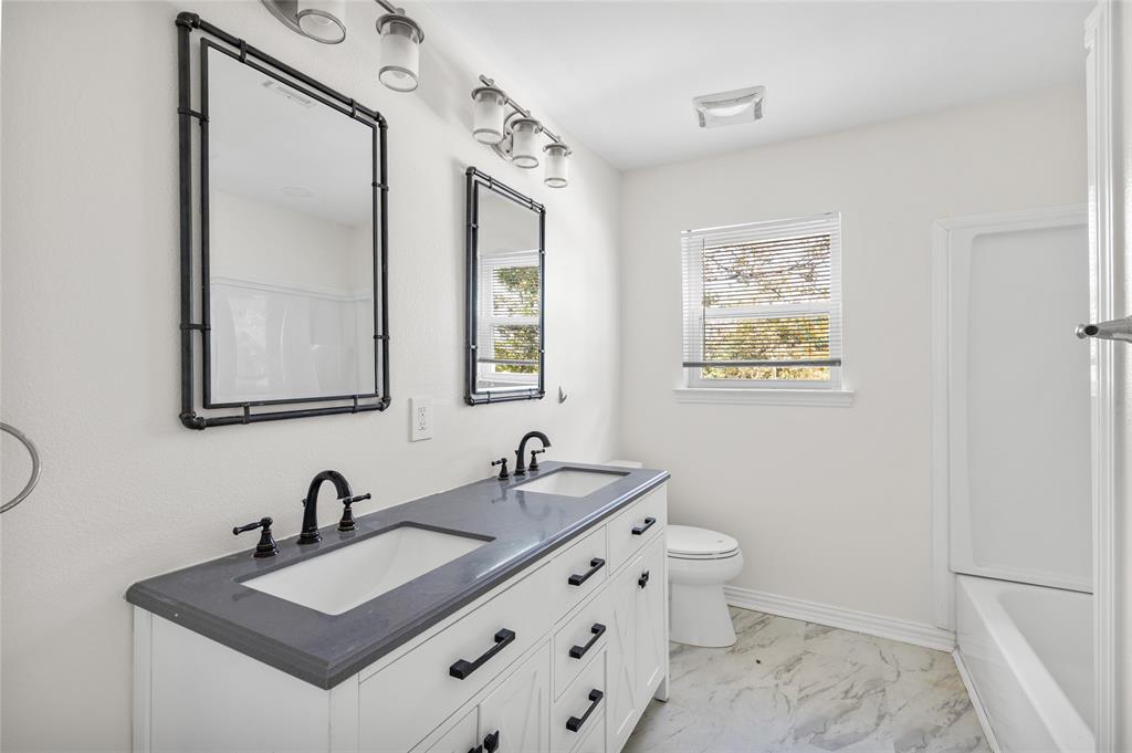 531 Coe Road Denison, TX 75021 - Photo 10 of 22 a bathroom with a sink and a mirror