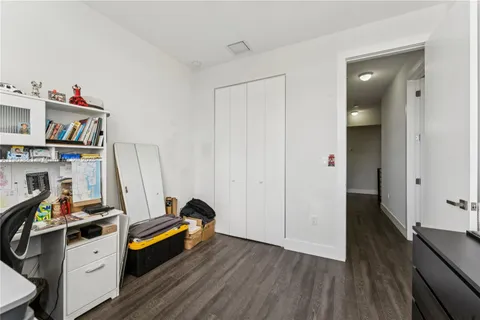 a view of a workspace with furniture and wooden floor