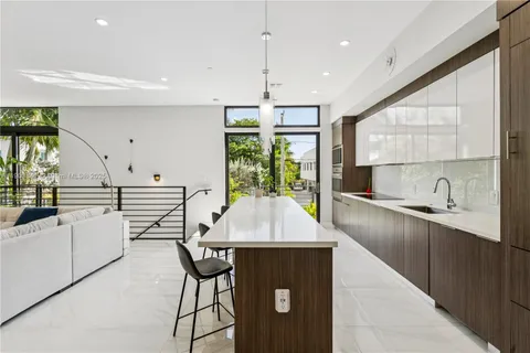 a kitchen with stainless steel appliances granite countertop sink stove and wooden cabinets