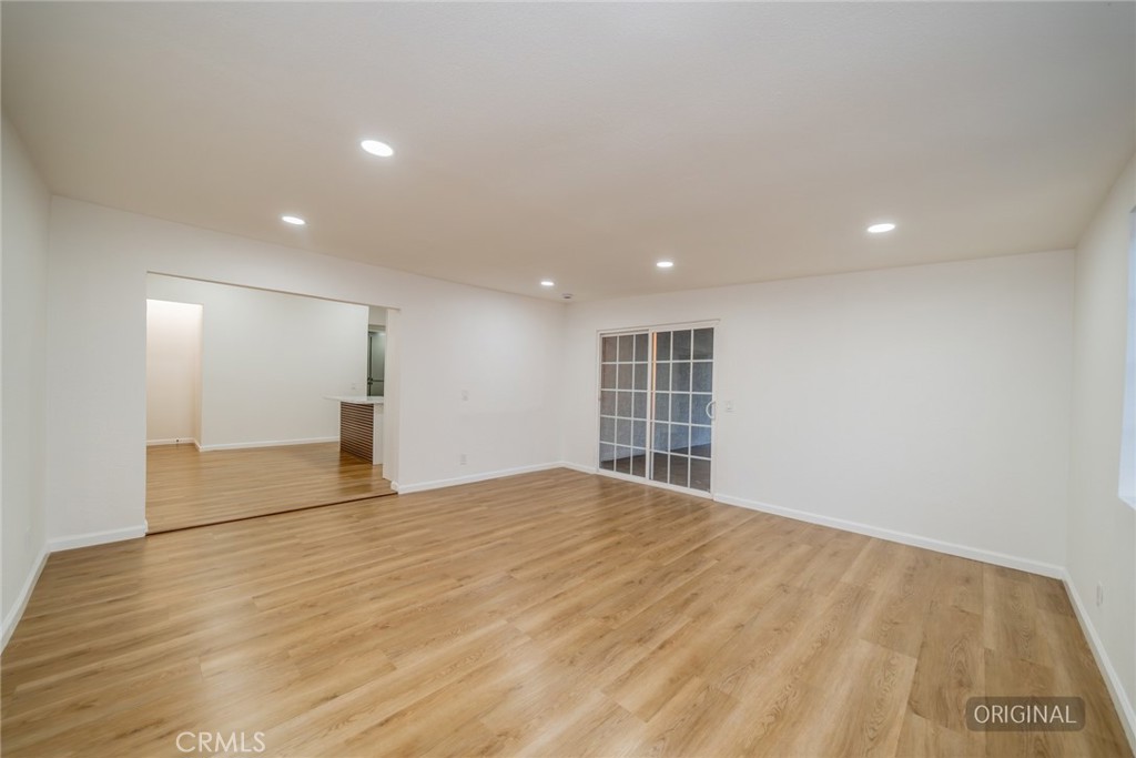 555 North Chestnut Avenue Rialto, CA 92376 - Photo 10 of 33 a view of empty room with wooden floor and windows