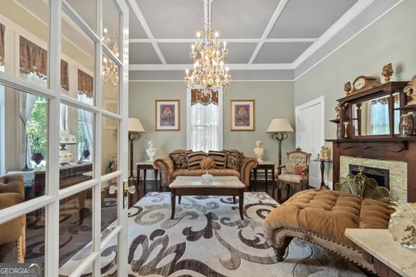 a living room with furniture a flat screen tv and a ceiling fan