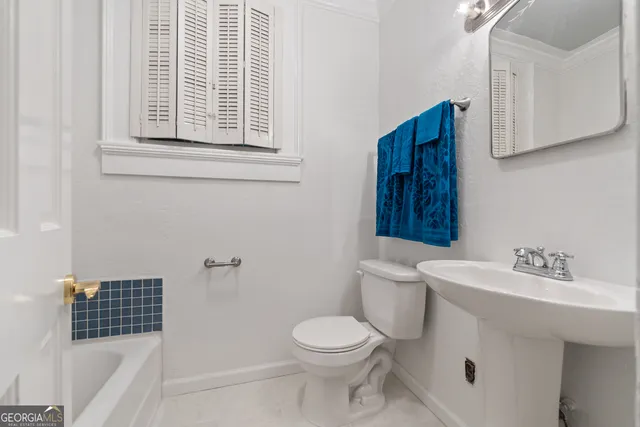 a bedroom with furniture and a flat screen tv