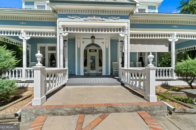 a living room with furniture a chandelier and a flat screen tv