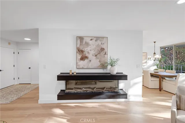 a living room with furniture a lamp and a potted plant