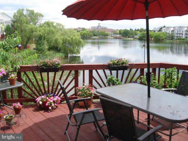 44072 Florence Terrace Ashburn, VA 20147 - Photo 3 of 14 a view of a chairs and table in patio with a lake view
