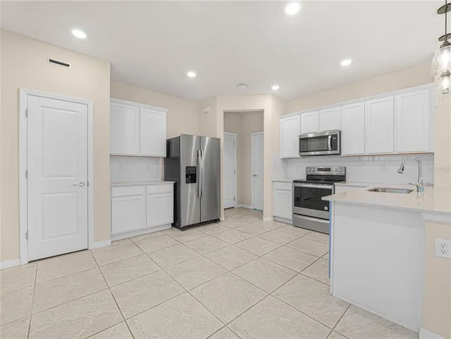 a view of kitchen with refrigerator and window