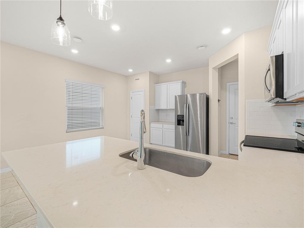 4580 Sparkling Shell Avenue Kissimmee, FL 34746 - Photo 18 of 42 a view of kitchen with refrigerator and window