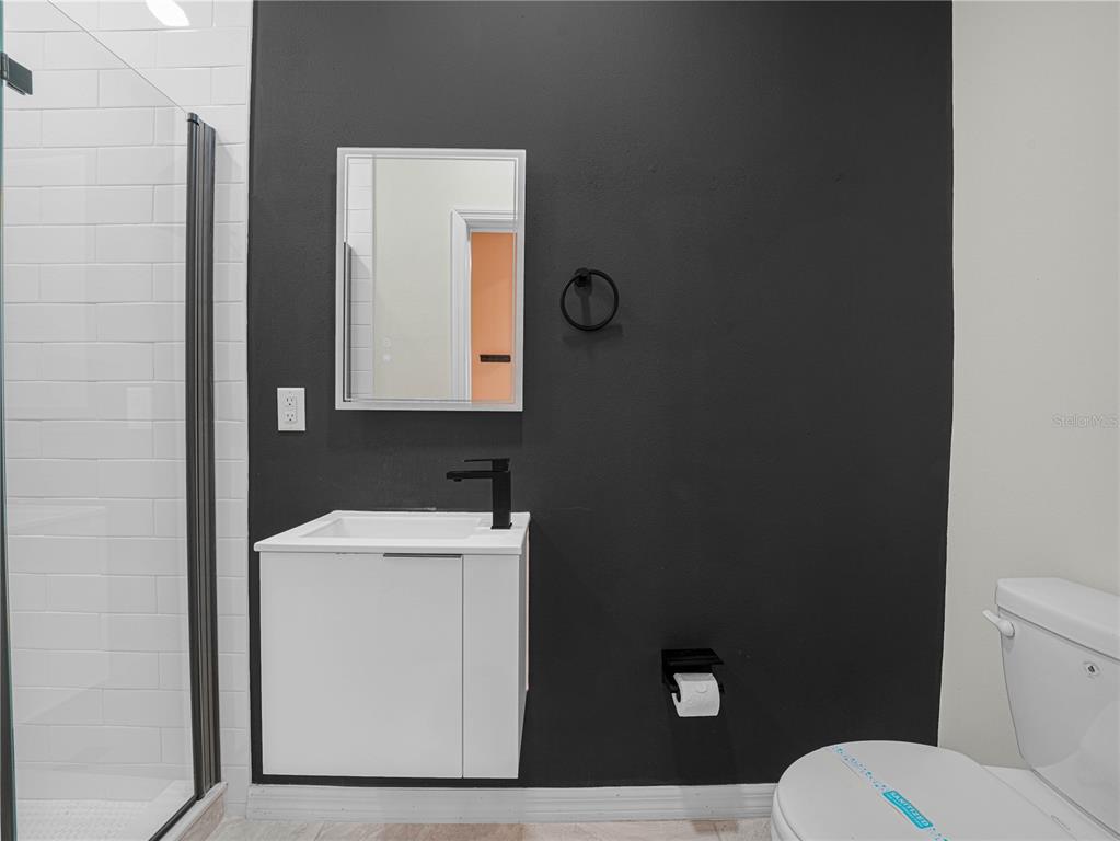 4580 Sparkling Shell Avenue Kissimmee, FL 34746 - Photo 21 of 42 a bathroom with a toilet a sink and mirror