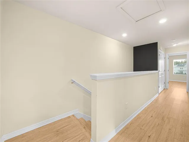 a view of hallway with wooden floor