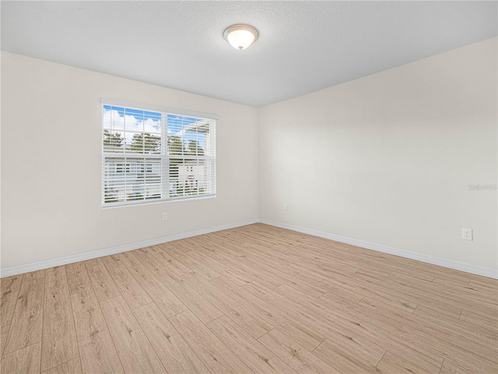 4580 Sparkling Shell Avenue Kissimmee, FL 34746 - Photo 32 of 42 wooden floor in an empty room with a window