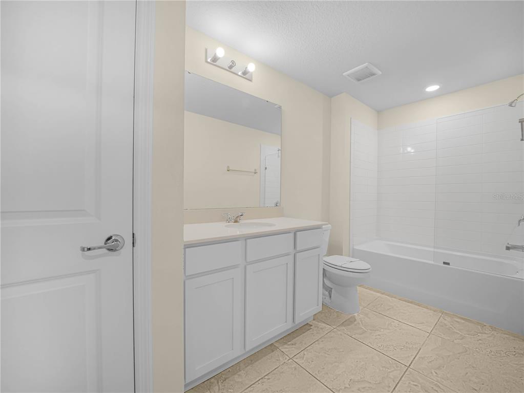 4580 Sparkling Shell Avenue Kissimmee, FL 34746 - Photo 35 of 42 a bathroom with a toilet sink and mirror