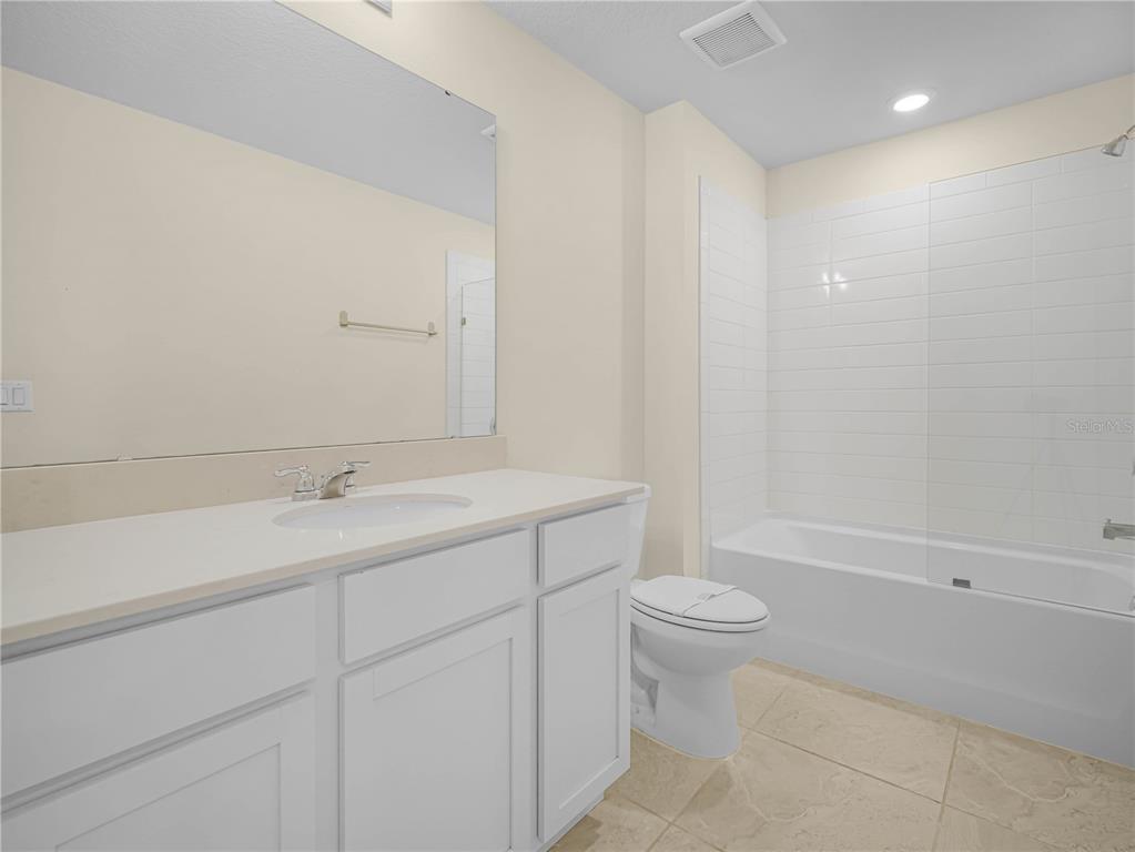 4580 Sparkling Shell Avenue Kissimmee, FL 34746 - Photo 36 of 42 a bathroom with a sink a toilet and a mirror