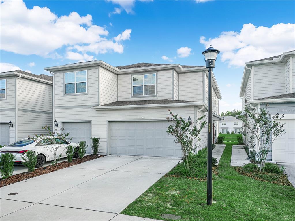 4580 Sparkling Shell Avenue Kissimmee, FL 34746 - Photo 40 of 42 a front view of a house with garden