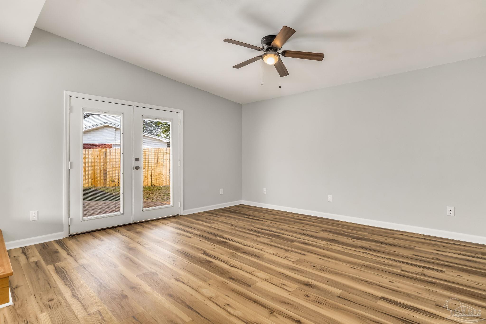 6357 Shady Lane Milton, FL 32570 - Photo 17 of 57 an empty room with wooden floor closet and windows