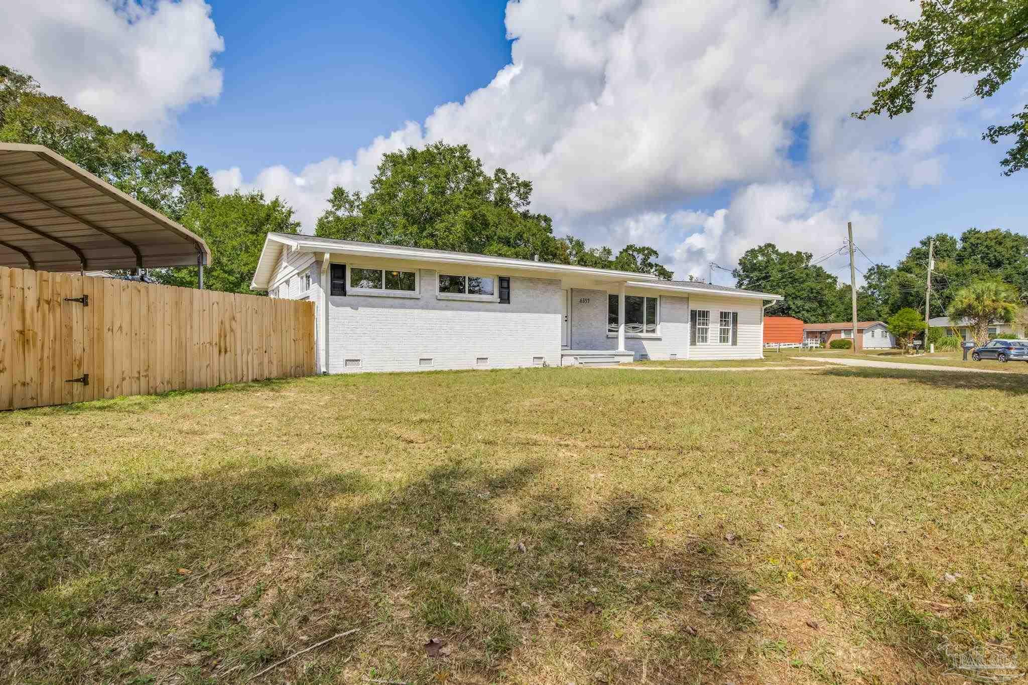 6357 Shady Lane Milton, FL 32570 - Photo 2 of 57 a view of house with yard and swimming pool
