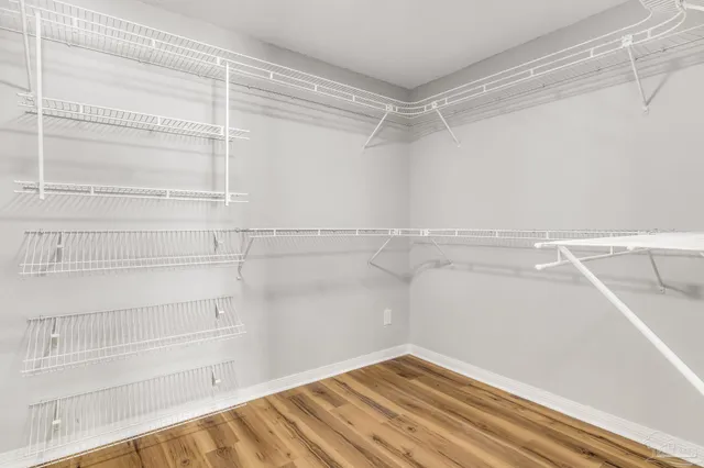 a spacious bathroom with a double vanity sink a mirror and a shower