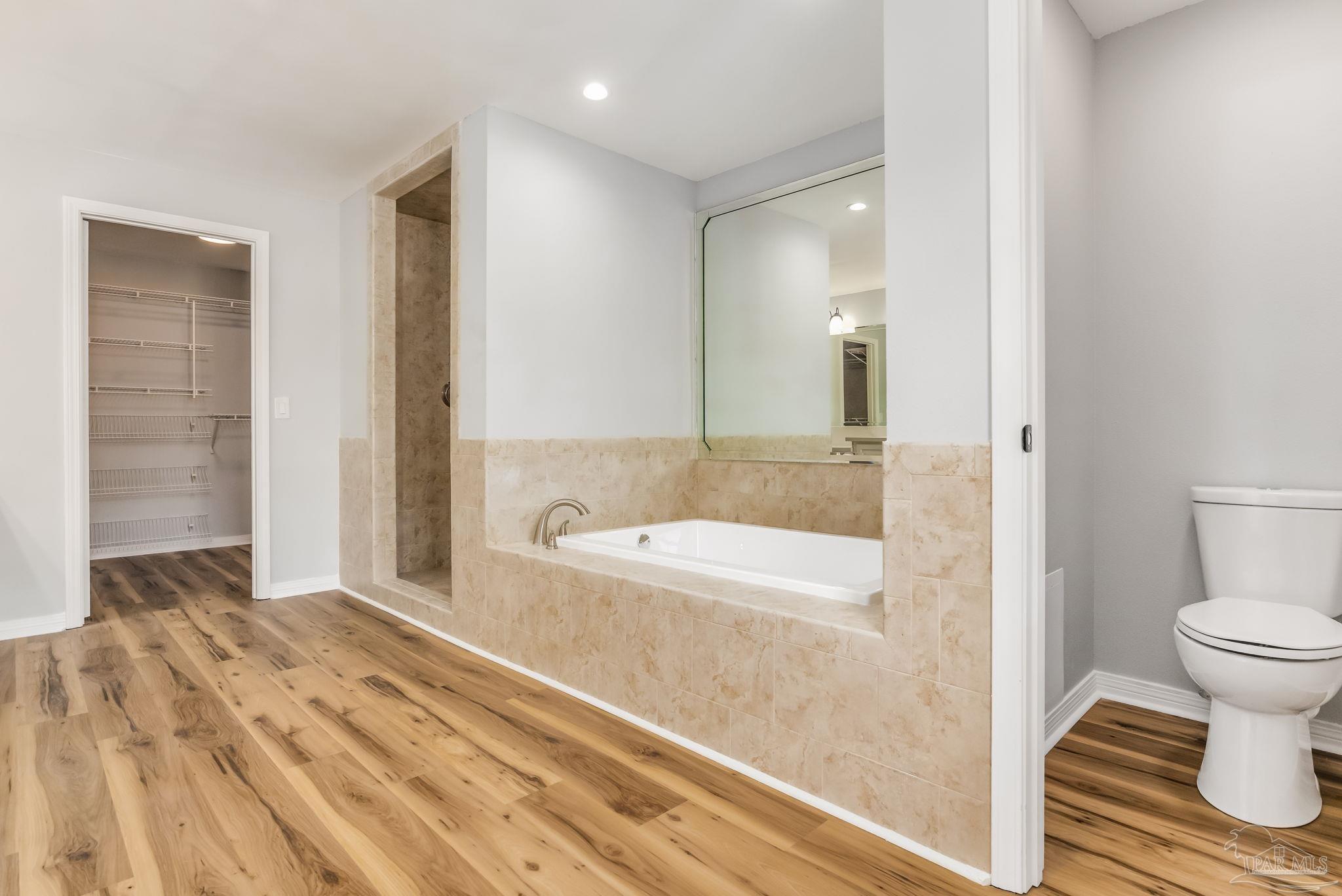 6357 Shady Lane Milton, FL 32570 - Photo 26 of 57 a bathroom with a bathtub and a toilet