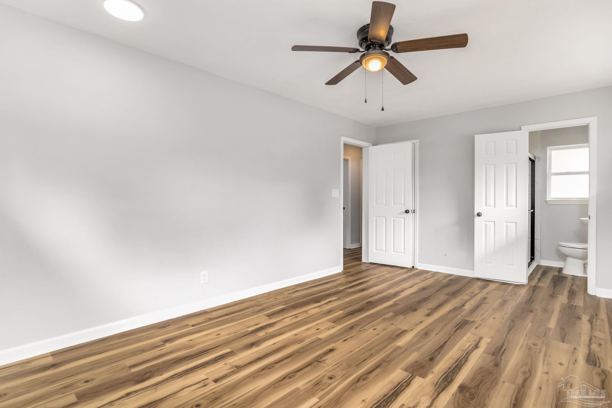 6357 Shady Lane Milton, FL 32570 - Photo 29 of 57 a view of empty room with wooden floor and fan