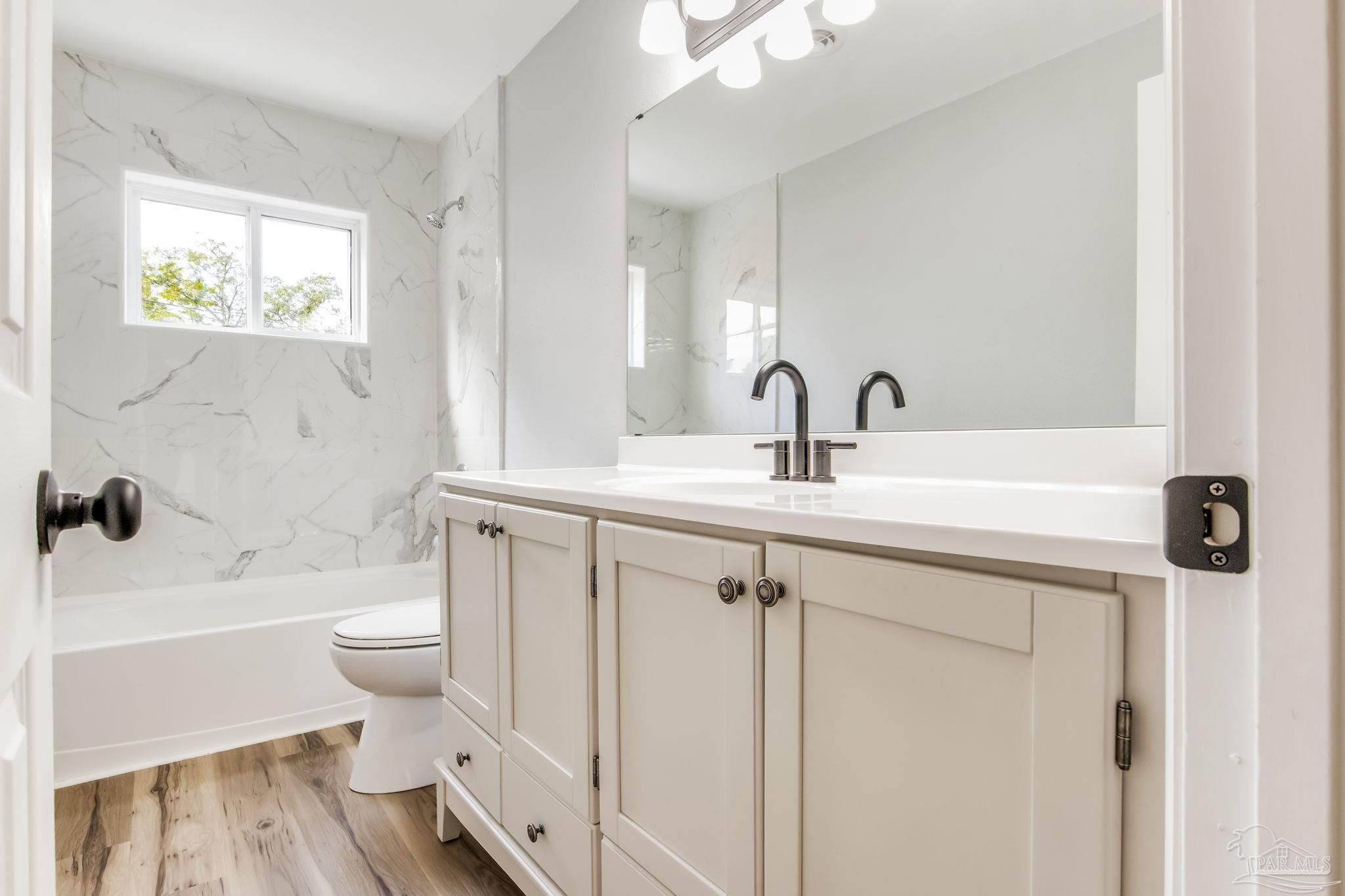 6357 Shady Lane Milton, FL 32570 - Photo 39 of 57 a bathroom with a sink and a toilet