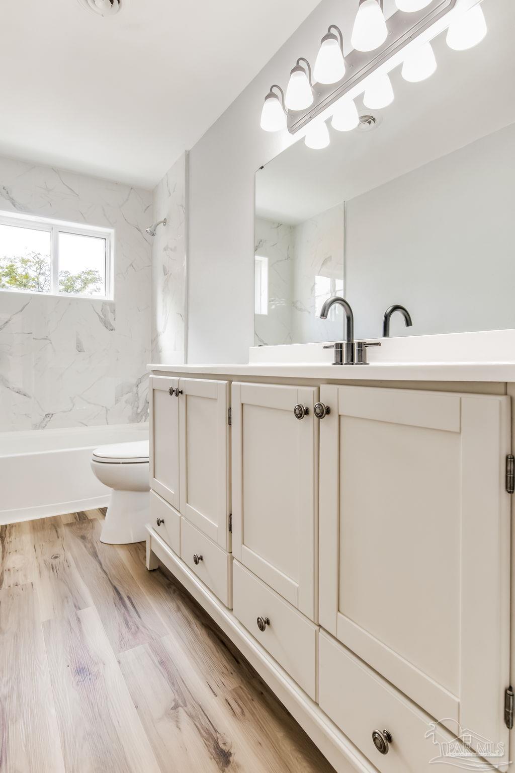 6357 Shady Lane Milton, FL 32570 - Photo 40 of 57 a bathroom with a sink a toilet and bathtub