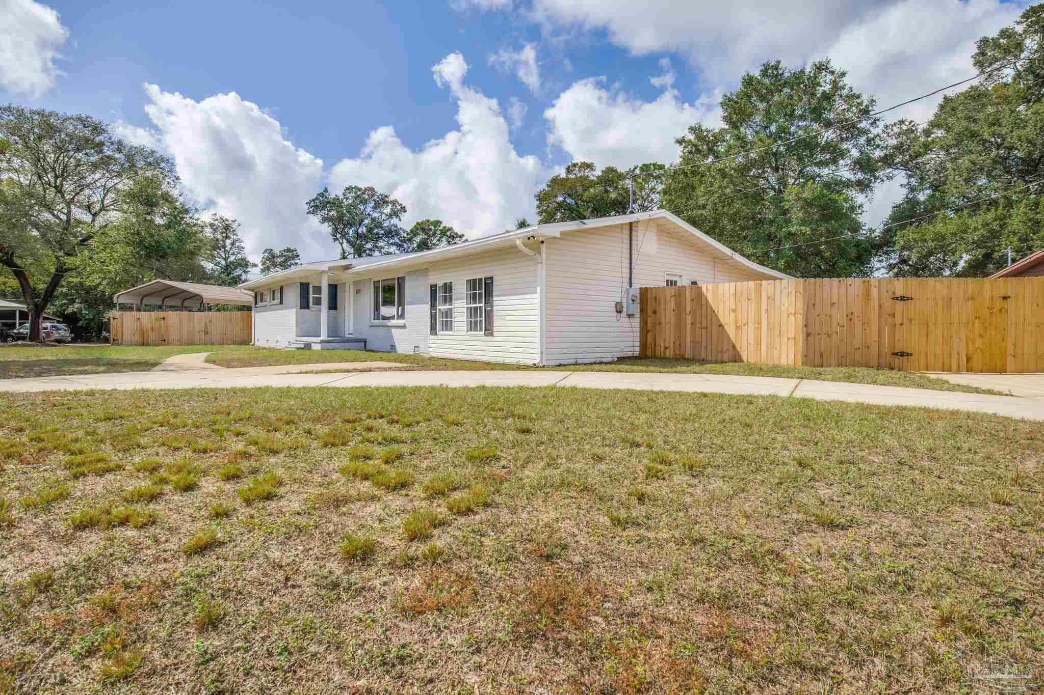 6357 Shady Lane Milton, FL 32570 - Photo 4 of 57 a front view of a house with a yard balcony and lake view