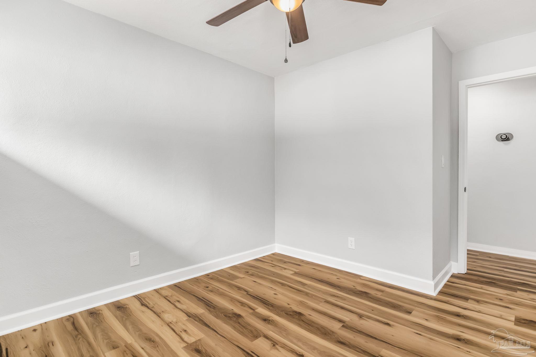 6357 Shady Lane Milton, FL 32570 - Photo 43 of 57 a view of empty room with wooden floor