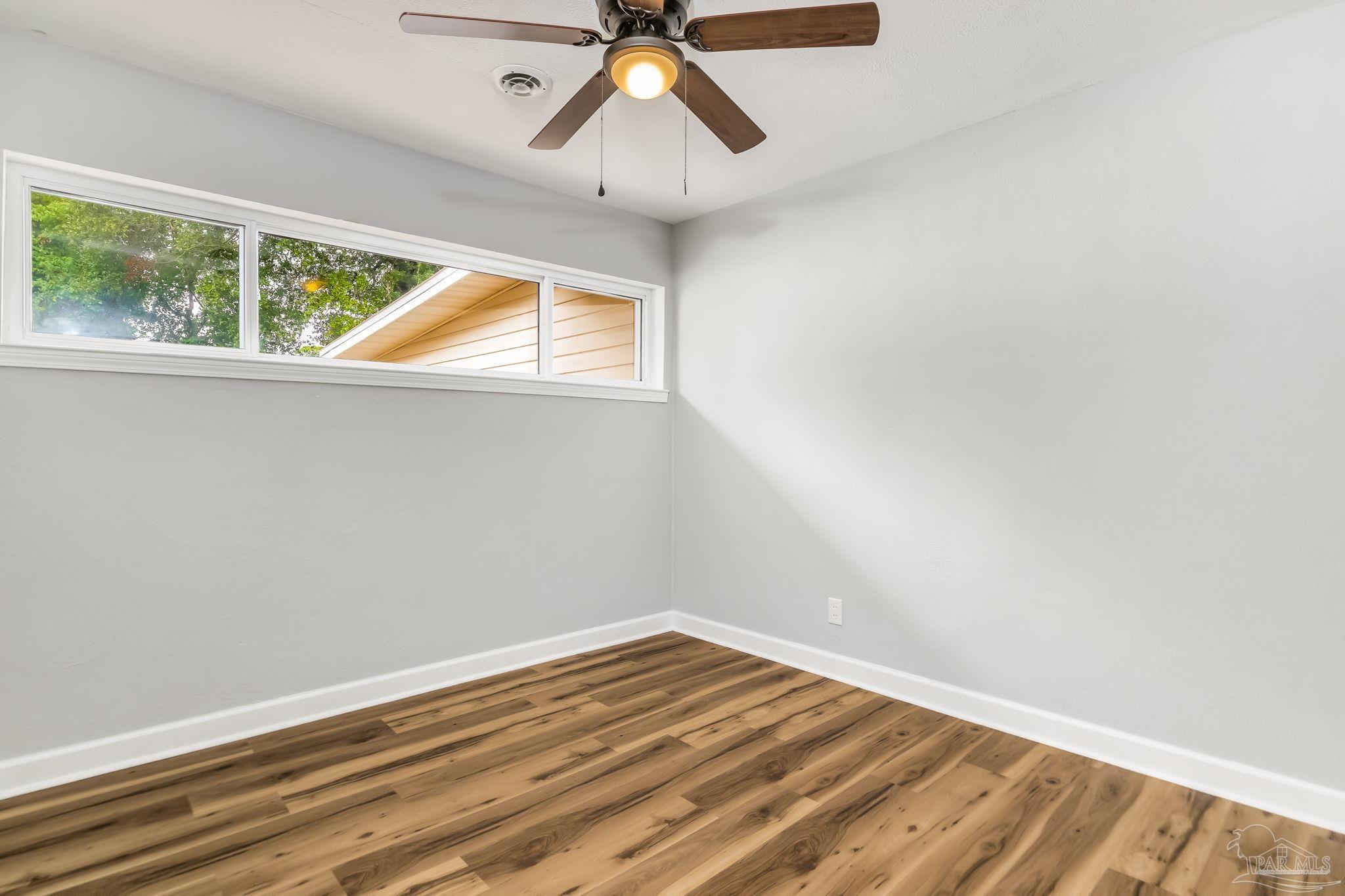 6357 Shady Lane Milton, FL 32570 - Photo 44 of 57 a view of empty room with wooden floor and fan