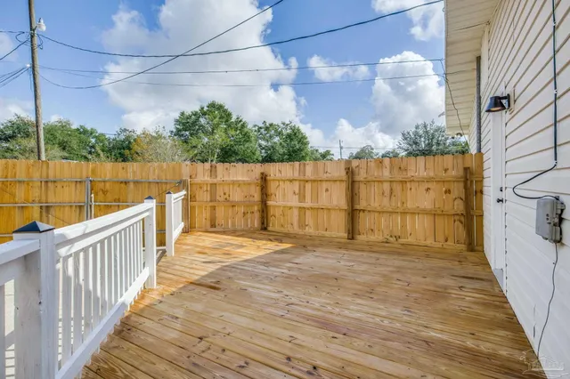 a view of a house with backyard and a tree