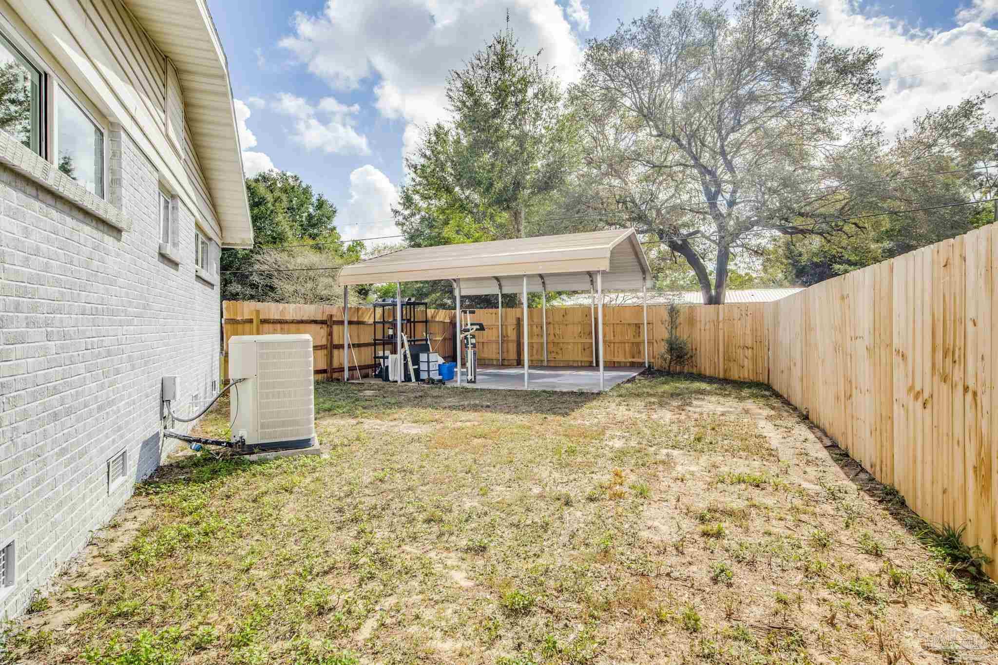6357 Shady Lane Milton, FL 32570 - Photo 55 of 57 a view of a house with backyard and a tree