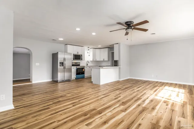 a view of a kitchen with a refrigerator and a window