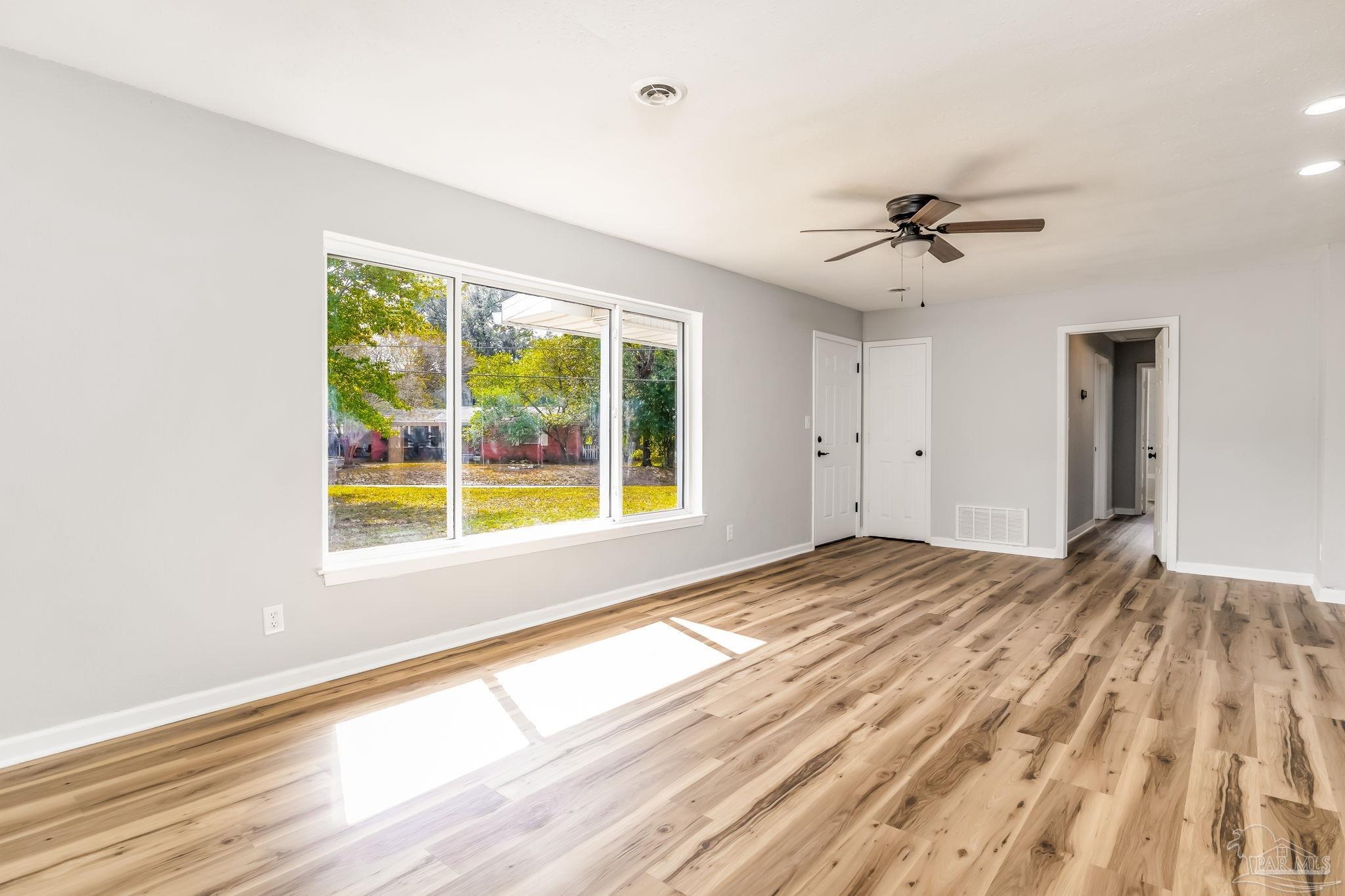 6357 Shady Lane Milton, FL 32570 - Photo 9 of 57 a view of empty room with wooden floor and fan