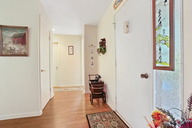a hallway with furniture and wooden floor