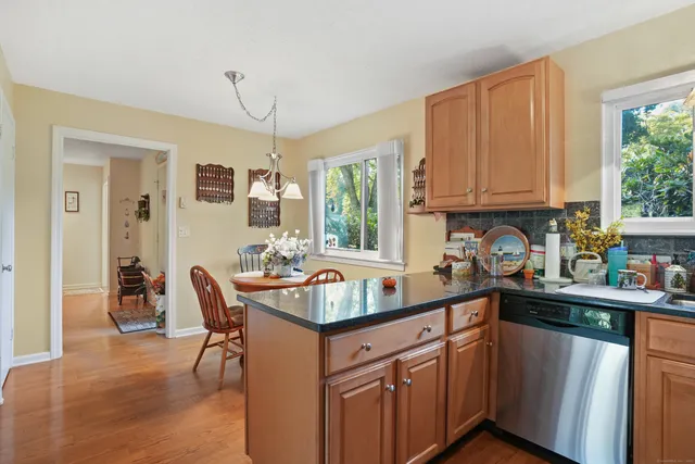 a kitchen with granite countertop a sink stove and cabinets