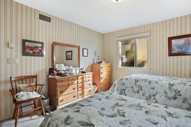 a bedroom with bed and furniture